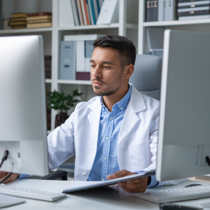 A psychiatry expert witness reviewing case files while conducting a telemedicine IME on a secure video platform.