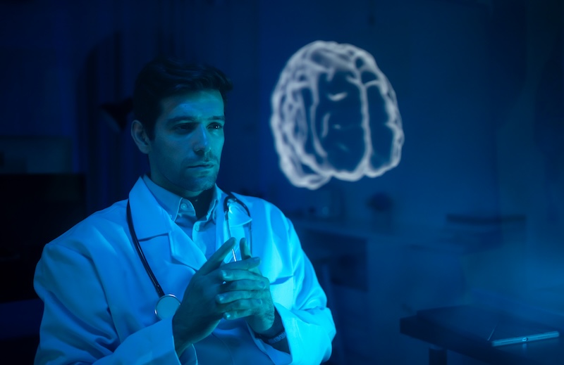 Physician analyzing a brain graphic